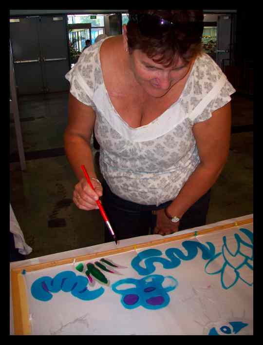 A lady learning how to paint on silk with Teena Hughes A lady learning how to paint on silk